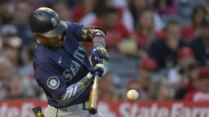 Julio Rodriguez #44 of the Seattle Mariners singles in the fifth inning against the Los Angeles Angels at Angel Stadium in 2024.