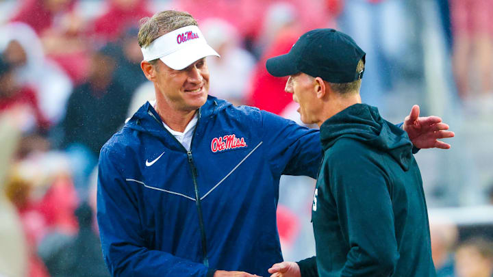 Oct 25, 2025; Norman, Oklahoma, USA; Ole Miss Rebels head coach Lane Kiffin (left) speaks with Oklahoma Sooners head coach Brent Venables (right) before the game at Gaylord Family-Oklahoma Memorial Stadium. Mandatory Credit: Kevin Jairaj-Imagn Images Oct 25, 2025; Norman, Oklahoma, USA; Ole Miss Rebels head coach Lane Kiffin (left) speaks with Oklahoma Sooners head coach Brent Venables (right) before the game at Gaylord Family-Oklahoma Memorial Stadium. Mandatory Credit: Kevin Jairaj-Imagn Images