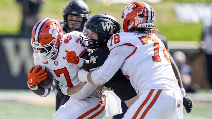 Oct 12, 2024; Winston-Salem, North Carolina, USA; Clemson Tigers running back Phil Mafah (7) is tackled by Wake Forest Demon Deacons linebacker Branson Combs (21) during the first half at Allegacy Federal Credit Union Stadium. 