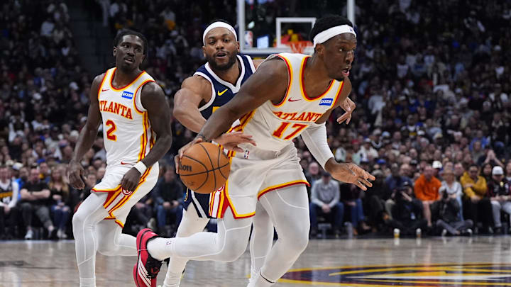 Jan 9, 2026; Denver, Colorado, USA; Denver Nuggets guard Bruce Brown (11) knocks the ball away from Atlanta Hawks forward Onyeka Okongwu (17) in the second half at Ball Arena. Mandatory Credit: Ron Chenoy-Imagn Images