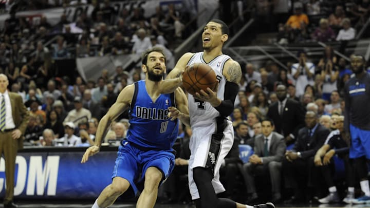 San Antonio Spurs guard Danny Green drives against Dallas Mavericks guard Jose Calderon.