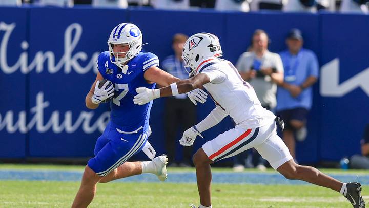 Sep 12, 2026; Provo, Utah, USA;  BYU Cougars quarterback Enoch Watson (17) runs after a catch against Arizona Wildcats safety Lee Molette III (17) during the second half at LaVell Edwards Stadium.  Mandatory Credit: Rob Gray-Imagn Images