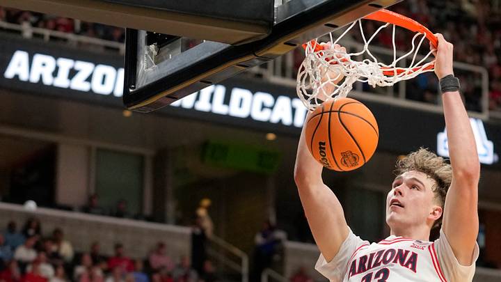 Mar 26, 2026; San Jose, CA, USA; Arizona Wildcats center Motiejus Krivas (13) dunks the ball past Arkansas Razorbacks forward Trevon Brazile (7) in the second half during a Sweet Sixteen game of the West Regional of the men's 2026 NCAA Tournament at SAP Center.