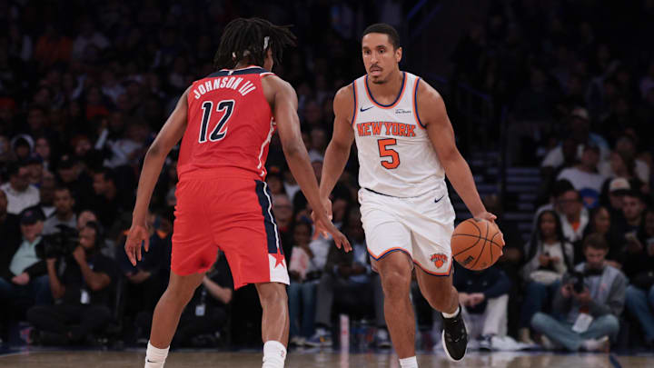 Oct 13, 2025; New York, New York, USA; New York Knicks guard Malcolm Brogdon (5) dribbles against Washington Wizards guard Tre Johnson (12)during the first half at Madison Square Garden. Mandatory Credit: Vincent Carchietta-Imagn Images