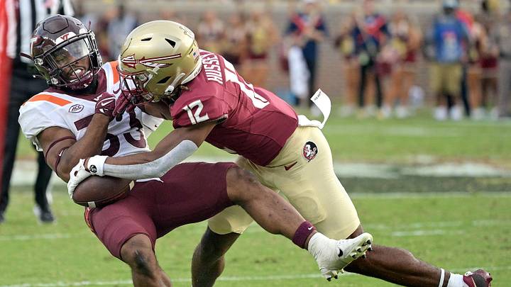 Oct 7, 2023; Tallahassee, Florida, USA; Florida State Seminoles defensive back Conrad Hussey (12) tackles Virginia Tech Hokies running back Bhayshul Tuten (33) during the second half against the at Doak S. Campbell Stadium. Mandatory Credit: Melina Myers-Imagn Images