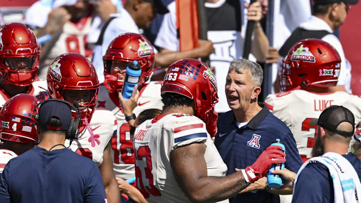 Oct 18, 2025; Houston, Texas, USA; Arizona Wildcats head coach Brent Brennan reacts in the huddle during the third quarter against the Houston Cougars at TDECU Stadium. Mandatory Credit: Maria Lysaker-Imagn Images Oct 18, 2025; Houston, Texas, USA; Arizona Wildcats head coach Brent Brennan reacts in the huddle during the third quarter against the Houston Cougars at TDECU Stadium. Mandatory Credit: Maria Lysaker-Imagn Images