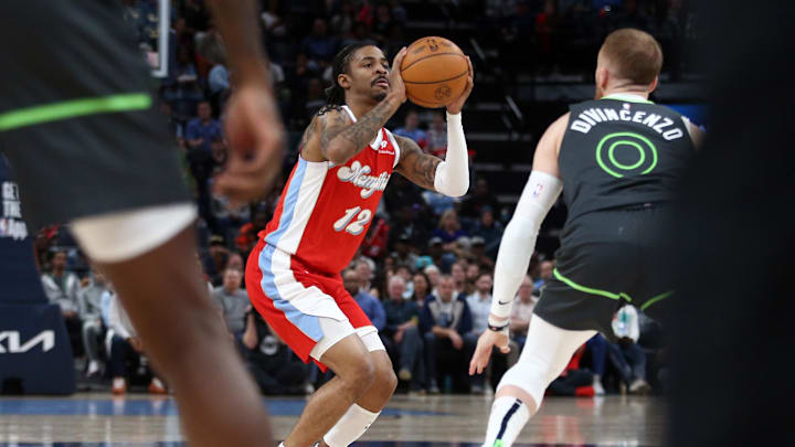 Apr 10, 2025; Memphis, Tennessee, USA; Memphis Grizzlies guard Ja Morant (12) shoots for three during the first quarter against the Minnesota Timberwolves at FedExForum. Mandatory Credit: Petre Thomas-Imagn Images