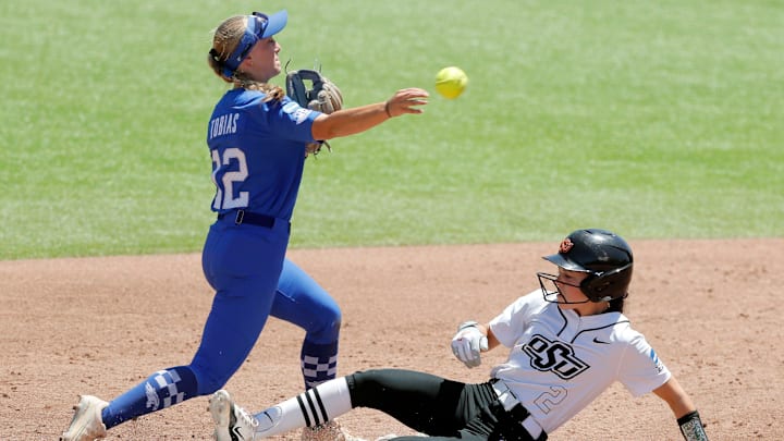 Kentucky infielder Margaret Tobias (12) throws over Oklahoma State infielder Sophie Page (2) to complete a double play in the third inning of a softball game between the Oklahoma State Cowgirls and Kentucky in the Stillwater Regional of the NCAA Tournament, Saturday, May 18, 2024. Oklahoma State qwon 6-2.