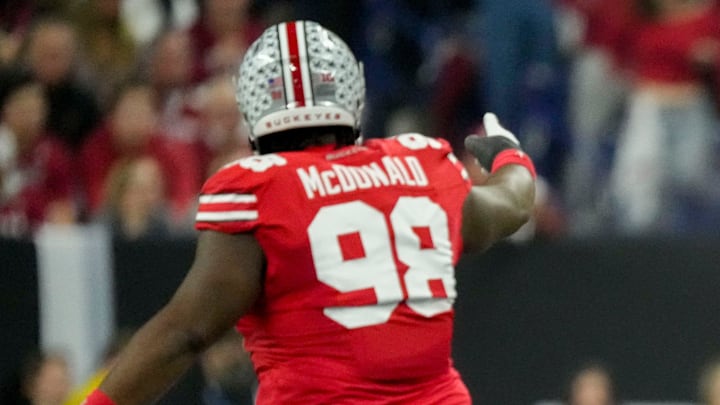 Ohio State Buckeyes defensive tackle Kayden McDonald (98) and Ohio State Buckeyes defensive end Caden Curry (92) celebrate a stop Saturday, Dec. 6, 2025, during the Big Ten football championship against the Indiana Hoosiers at Lucas Oil Stadium in Indianapolis.