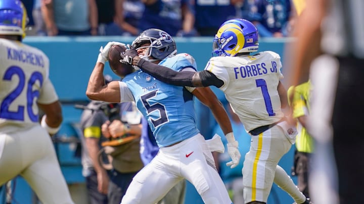 Tennessee Titans wide receiver Elic Ayomanor pulls the ball down ahead of Los Angeles Rams cornerback Emmanuel Forbes Jr.