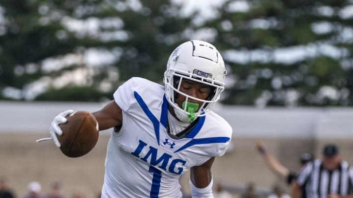 IMG Academy High School junior Donovan Olugbode (1) works to stay in-bounds after a reception during the first half of an IHSAA varsity football game against Ben Davis High School, Friday, Sept. 8, 2023, at Ben Davis High School.