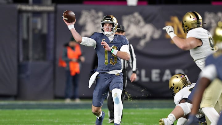 Nov 23, 2024; New York, New York, USA; Notre Dame Fighting Irish quarterback Riley Leonard (13) throws a pass against the Army Black Knights during the first half at Yankee Stadium. Mandatory Credit: Danny Wild-Imagn Images