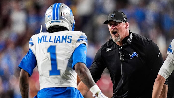 Detroit Lions head coach Dan Campbell celebrates with wide receiver Jameson Williams (1).