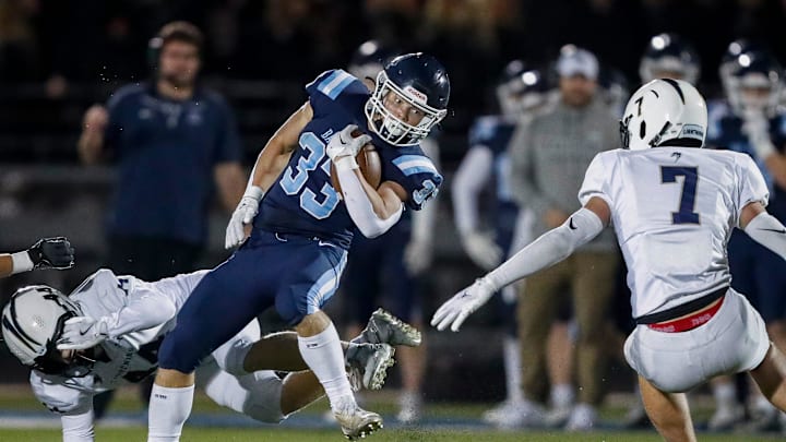 Bay Port High School's Brady Moon (33) spins away from Appleton North High School's Cole Hank (44) during a WIAA Division 1 first round playoff game on Friday, October 24, 2025, at Bay Port High School in Suamico, Wis. Bay Port won the game, 41-6.
Tork Mason/USA TODAY NETWORK-Wisconsin