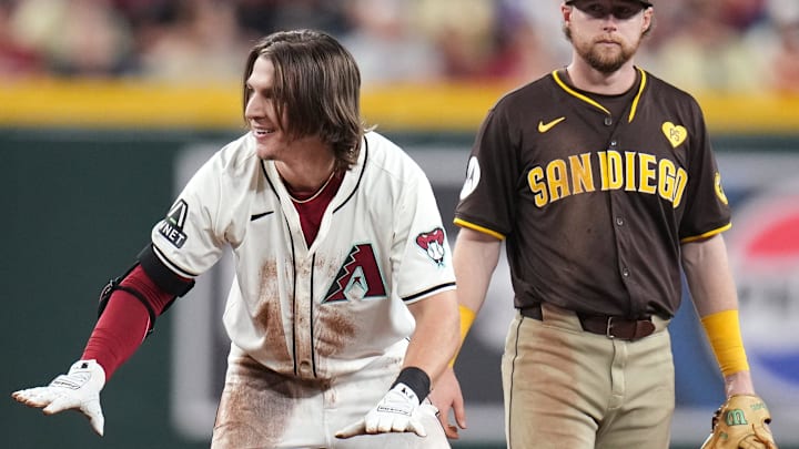 Arizona Diamondbacks Jake McCarthy (31) gestures towards his teammates after sliding safely back into second base while overrunning his double against the San Diego Padres at Chase Field in Phoenix on Sept. 29, 2024.
