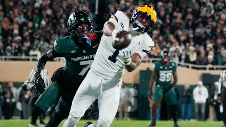 Oct 25, 2025; East Lansing, Michigan, USA; Michigan Wolverines wide receiver Donaven McCulley (1) is unable to make the catch as Michigan State Spartans cornerback Joshua Eaton (7) defends during the first half at Spartan Stadium. Mandatory Credit: Brendan Mullin-Imagn Images