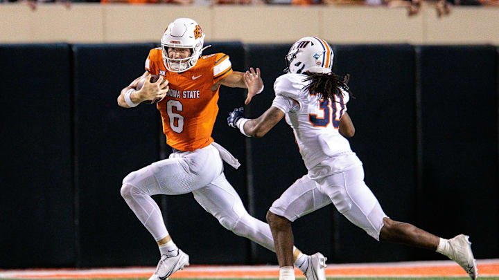 Aug 28, 2025; Stillwater, Oklahoma, USA; Oklahoma State Cowboys quarterback Zane Flores (6) runs the ball around Tennessee Martin Skyhawks safety Zamaryion Farmer-McCray (30) during the second half at Boone Pickens Stadium. Mandatory Credit: William Purnell-Imagn Images