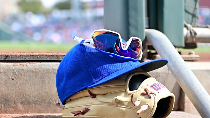 General view of a Chicago Cubs glove, hat and glasses in the first inning against the Cincinnati Reds during a spring training game at Sloan Park in 2024.