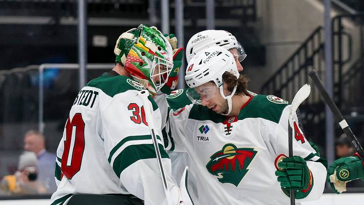 Oct 27, 2026; Salt Lake City, Utah, USA;  Minnesota Wild goaltender Jesper Wallstedt (30) and defenseman Quinn Hughes