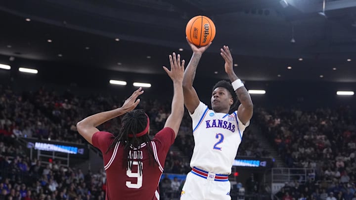 Mar 20, 2025; Providence, RI, USA;  Kansas Jayhawks guard AJ Storr (2) shoots the ball against Arkansas Razorbacks forward Jonas Aidoo (9) during the second half at Amica Mutual Pavilion. Mandatory Credit: Gregory Fisher-Imagn Images