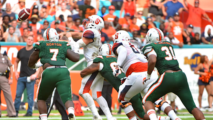Oct 21, 2017; Miami Gardens, FL, USA; Miami Hurricanes defensive lineman RJ McIntosh (80) hits Syracuse Orange quarterback Eric Dungey (2) during the first half at Hard Rock Stadium. Mandatory Credit: Jasen Vinlove-Imagn Images