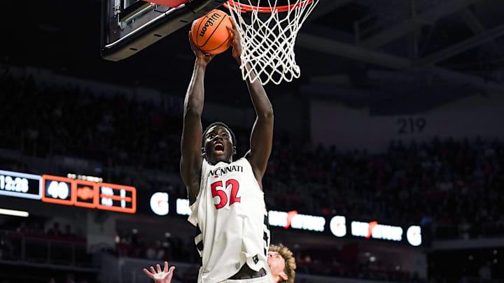 Cincinnati Bearcats center Moustapha Thiam (52) hits a layup in the second half of a NCAA men’s basketball game between the Cincinnati Bearcats and Oklahoma State Cowboys, Saturday, Feb. 28, 2026, at Fifth Third Arena in Cincinnati. Bearcats won 91-68.