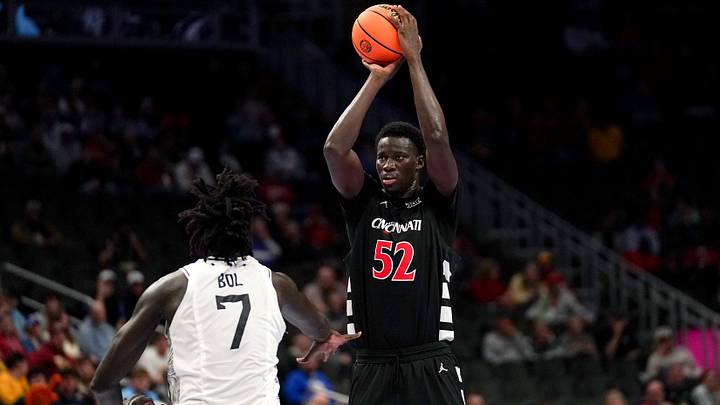 Cincinnati Bearcats center Moustapha Thiam (52) makes a basket from three point range in the first half of the second round of the Phillips 66 Big 12 Men’s Basketball Tournament between the Cincinnati Bearcats and UCF Knights, Wednesday, March 11, 2026, at T-Mobile Center in Kansas City, MO.