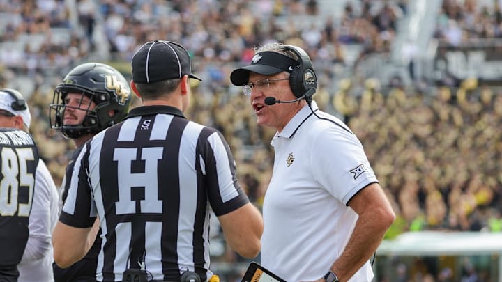 Nov 25, 2023; Orlando, Florida, USA; UCF Knights head coach Gus Malzahn talks to Head Linesman Any Warner during a play review in the first quarter against the Houston Cougars at FBC Mortgage Stadium. Mandatory Credit: Mike Watters-Imagn Images