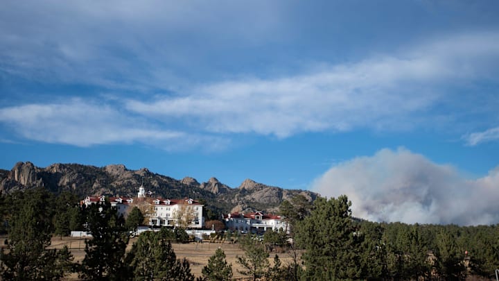 Smoke from the Cameron Peak Fire drifts through the sky behind the Stanley Hotel outside Estes Park, Colo. on Friday, Oct. 16, 2020.