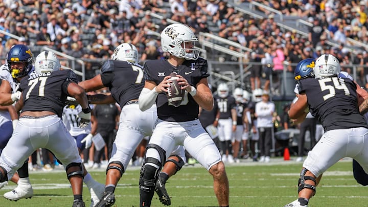 Oct 28, 2023; Orlando, Florida, USA; UCF Knights quarterback John Rhys Plumlee (10) prepares to pass