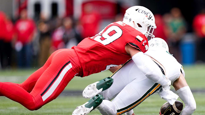 Cincinnati Bearcats linebacker Jack Dingle (49) tackles Baylor Bears quarterback Sawyer Robertson (13) in the first quarter of a NCAA men’s football game between the Cincinnati Bearcats and Baylor Bears, Saturday, Oct. 25, 2025, at Nippert Stadium in Cincinnati. Cincinnati Bearcats linebacker Jack Dingle (49) tackles Baylor Bears quarterback Sawyer Robertson (13) in the first quarter of a NCAA men’s football game between the Cincinnati Bearcats and Baylor Bears, Saturday, Oct. 25, 2025, at Nippert Stadium in Cincinnati.
