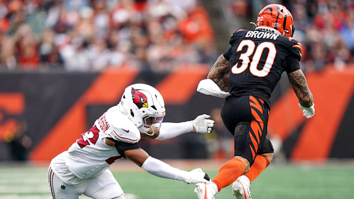 Arizona Cardinals safety Dadrion Taylor-Demerson (42) misses a tackle on Cincinnati Bengals running back Chase Brown (30) in the second quarter of a NFL game between the Cincinnati Bengals and Arizona Cardinals, Sunday, Dec. 28, 2025, at Paycor Stadium in downtown Cincinnati.