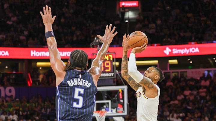 Nov 4, 2023; Orlando, Florida, USA; Los Angeles Lakers guard D'Angelo Russell (1) shoots the ball against Orlando Magic forward Paolo Banchero (5) during the first quarter at Amway Center. Mandatory Credit: Mike Watters-USA TODAY Sports Nov 4, 2023; Orlando, Florida, USA; Los Angeles Lakers guard D'Angelo Russell (1) shoots the ball against Orlando Magic forward Paolo Banchero (5) during the first quarter at Amway Center. Mandatory Credit: Mike Watters-USA TODAY Sports