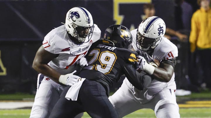 Sep 19, 2024; Boone, North Carolina, USA;  South Alabama Jaguars offensive lineman Kenton Jerido (69) and offensive lineman Malachi Carney (77) block Appalachian State Mountaineers defensive end Santana Hopper (29) during the second half at Kidd Brewer Stadium. Mandatory Credit: Reinhold Matay-Imagn Images