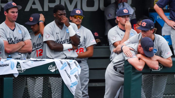 Dejected Auburn players look on as Coastal Carolina celebrates eliminating Auburn in the NCAA Baseball Super Regional at Plainsman Park in Auburn, Ala., on Friday June 6, 2025.