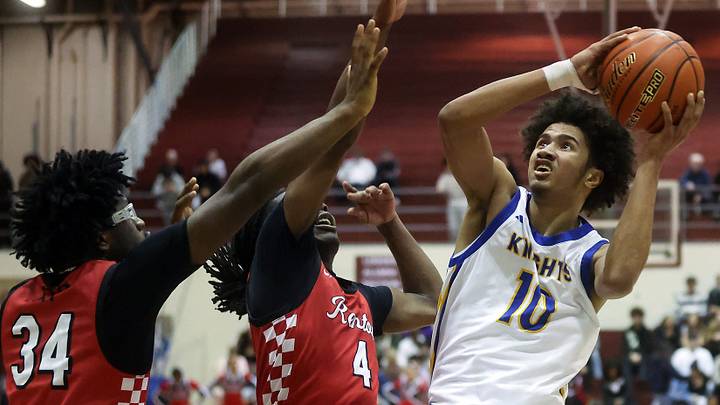 Bremerton’s Jalen Davis (10) goes up for a basket over Renton’s Nate Omar (4) and Suhail Abdulmumin (34) on Saturday, Feb. 28 at the University of Puget Sound's Memorial Fieldhouse. Bremerton’s Jalen Davis (10) goes up for a basket over Renton’s Nate Omar (4) and Suhail Abdulmumin (34) on Saturday, Feb. 28 at the University of Puget Sound's Memorial Fieldhouse.