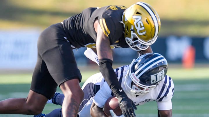 Alabama State defensive cornerback James Burgess (2) tackles Jackson State running back Travis Terrell, Jr., (0) during their SWAC matchup on the ASU campus in Montgomery, Ala., on Saturday November 16, 2024.