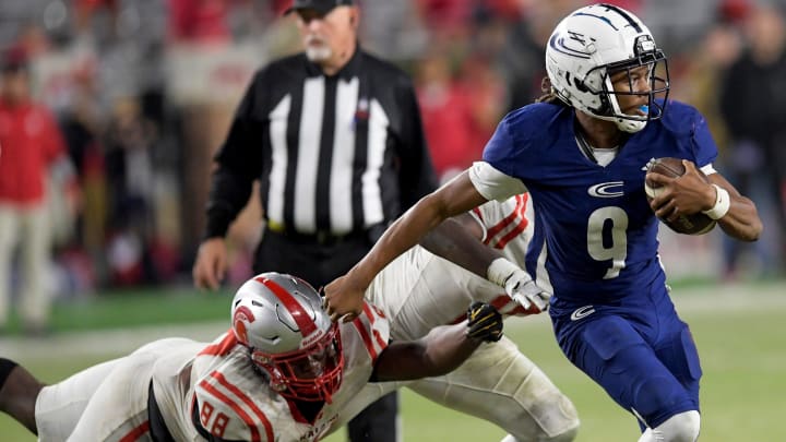 Clay-Chalkville's Jaylen Mbakwe (9) eludes Saraland's Jermaine Paramore, Jr., (88) and Camron Laffitte (10) during the AHSAA Class 6A football state championship game at Bryant Denny Stadium in Tuscaloosa, Ala., on Friday December 8, 2023.