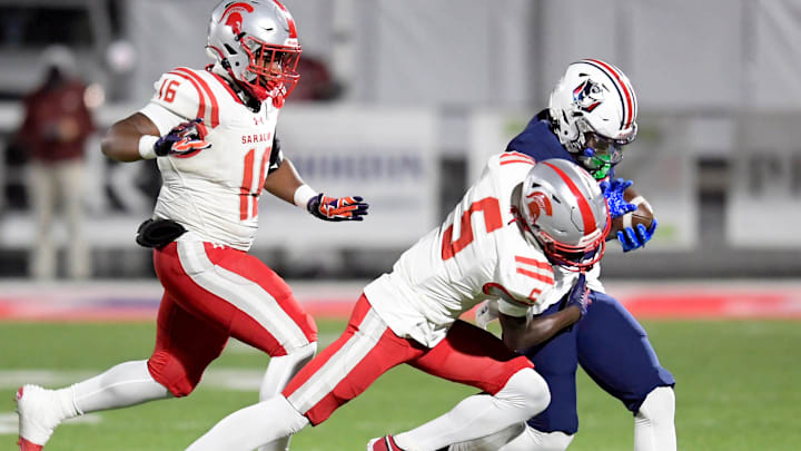 Saraland's Tamidrae Sewer (5) forces Pike Road's Omari Smith (0) out of bounds during their AHSAA football playoff game on the Pike Road High School campus in Pike Road, Ala., Friday evening November 29, 2024.