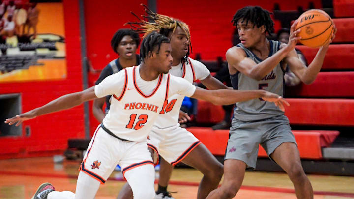 (5) is double teamed by Percy Julian's Aiden McKinley-Scott (12) and Jaden Moore (10) during their game at the Percy Julian campus in Montgomery, Ala., on Saturday January 4, 2025. (5) is double teamed by Percy Julian's Aiden McKinley-Scott (12) and Jaden Moore (10) during their game at the Percy Julian campus in Montgomery, Ala., on Saturday January 4, 2025.