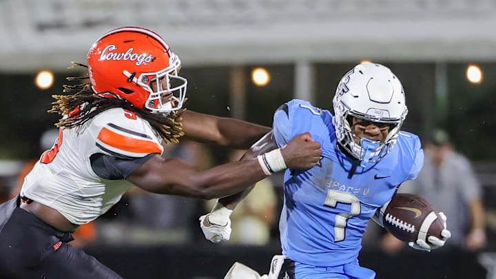 Nov 11, 2023; Orlando, Florida, USA; UCF Knights running back RJ Harvey (7) runs the ball against Oklahoma State Cowboys safety Trey Rucker (9) during the second half at FBC Mortgage Stadium. Mandatory Credit: Mike Watters-Imagn Images