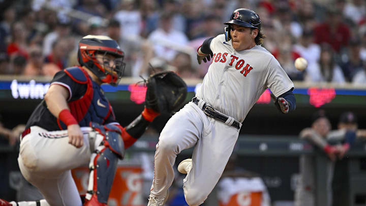Jun 20, 2023; Minneapolis, Minnesota, USA;  Boston Red Sox infielder Triston Casas (36) beats the tag of Minnesota Twins catcher Ryan Jeffers (27) to score a run during the seventh inning at Target Field. Mandatory Credit: Nick Wosika-Imagn Images