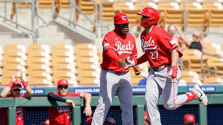 Cincinnati Reds third base coach Willie Harris (99) gives first baseman Sal Stewart (27) a high five after hitting a homer in the second inning of a Cactus League game between the Cincinnati Reds and Chicago White Sox, Wednesday, Feb. 25, 2026, at