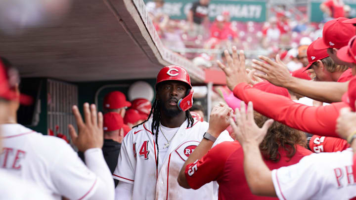 Cincinnati Reds shortstop Elly de la Cruz (44) is embraced by teammates in the dugout after scoring a homer in the ninth inning of a MLB game between the Cincinnati Reds and Los Angeles Angels, Sunday, April 12, 2026, at Great American Ball Park in downtown Cincinnati. Reds loss 9-6.