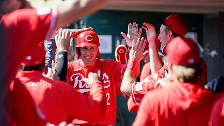 Cincinnati Reds right fielder JJ Bleday (22) is embraced by teammates in the dugout after hitting a homer in the third inning of a Cactus League game between the Cincinnati Reds and Chicago White Sox, Wednesday, Feb. 25, 2026, at