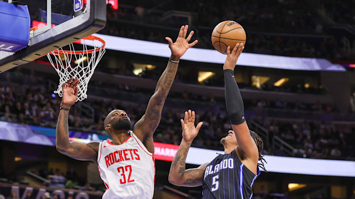 Mar 19, 2025; Orlando, Florida, USA; Orlando Magic forward Paolo Banchero (5) goes to the basket against Houston Rockets forward Jeff Green (32) during the second quarter at Kia Center. Mandatory Credit: Mike Watters-Imagn Images