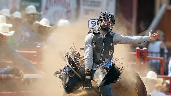 The dust flies as bull rider Hayes Thayne Weight, of Goshen, Utah, rides a bull named Longmire during the PRCA Xtreme Bulls rodeo in Thunderbird Arena at the Kitsap Fair & Stampede in Bremerton, Wash. on Saturday, Aug. 26, 2023.