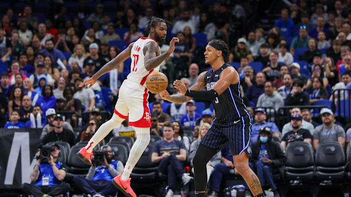 Orlando Magic forward Paolo Banchero passes the ball in front of Houston Rockets forward Tari Eason.