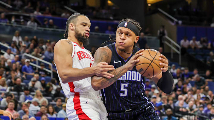 Orlando Magic forward Paolo Banchero drives to the basket against Houston Rockets forward Dillon Brooks.