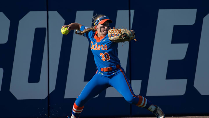 Jun 1, 2024; Oklahoma City, OK, USA;  Florida Gators outfielder Korbe Otis (33) throws the ball to second after a Texas Longhorns hit in the first inning during a Women's College World Series softball winners bracket game at Devon Park. Mandatory Credit: Brett Rojo-Imagn Images